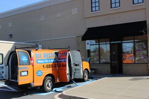 Water Damage Restoration Van At Exterior Job Site